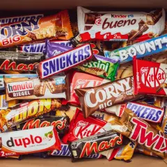 Pudełko pełne słodyczy: Snickers, Mars, Twix, Bounty, Kinder Bueno, Corny, Duplo i inne popularne polskie marki słodyczy.
