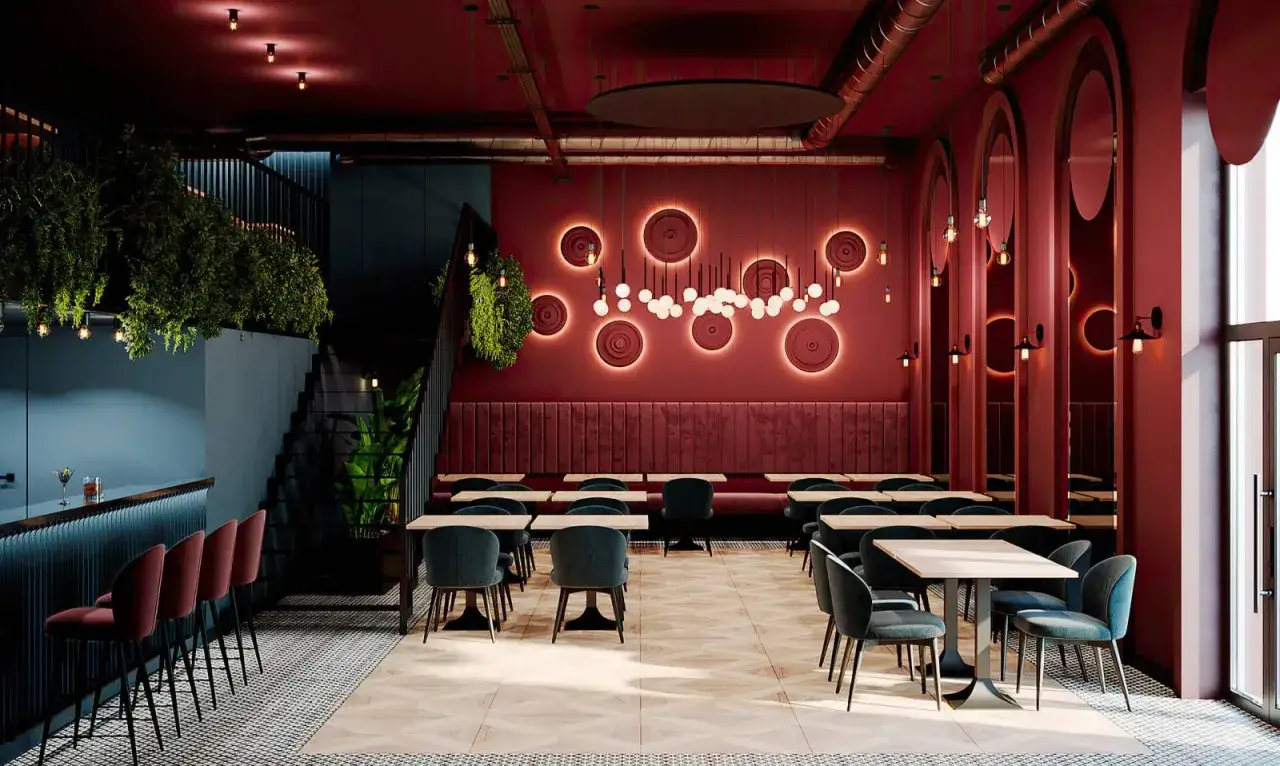Nowoczesne wnętrze z roślinnością i designerskim oświetleniem. Idealne miejsce na odkrycie ciekawych restauracji w Warszawie.